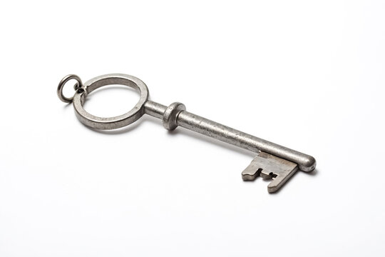 Close-up of a silver key on a white background