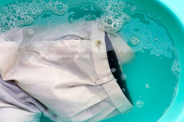 Trousers soaked in powder detergent water dissolution, washing cloth. Laundry concept