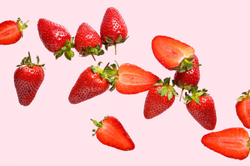 Flying sweet strawberries on pink background