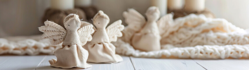 Hand-sewn fabric angels with embroidered details on white background