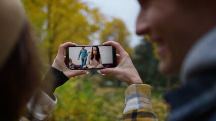 Young people calling sister online closeup. Smiling woman talking in smartphone