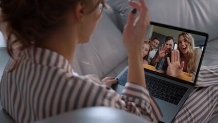 Smiling family chat online in laptop screen closeup. Happy friends videocalling
