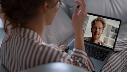 Smiling man videocalling woman in screen closeup. Young couple talking remotely