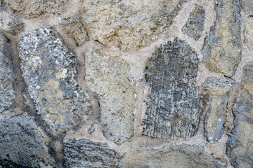 The mansion uses beachrock for its walls / fence. Beachrock is sedimentary rock that consists of a variable mixture of gravel, sand, and silt-sized sediment. fragments of coral and shells .