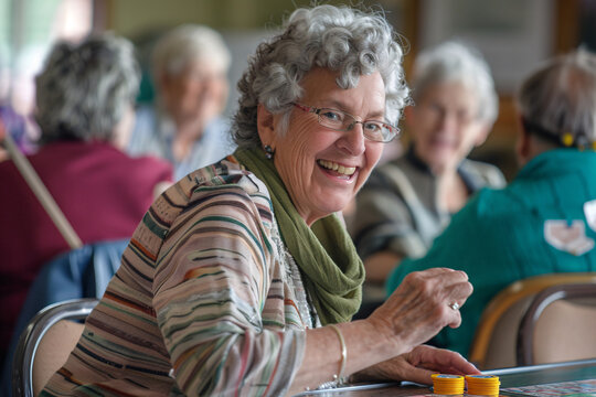 Seniors playing a spirited game of bingo at a community center, Stock Photo with copy space