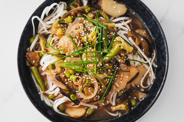 asian inspired rice noodle soup with green beans eggplant and water chestnuts