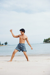 Muscular Asian Athlete Running on the Beach, Embracing a Healthy Lifestyle