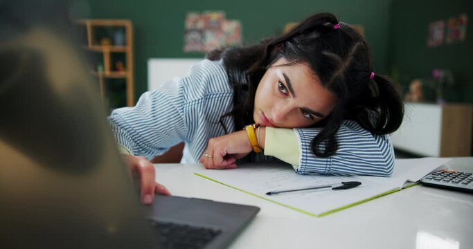 Girl, online and student tired with laptop for studying for important exam or assignment, burnout and mental block or fatigue. Learner, digital technology and research for assessment and education.