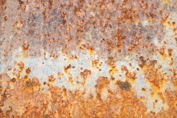 Corroded metal background. Rusted grey painted metal wall. Rusty metal background with streaks of rust. Rust stains.