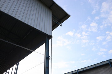 A large and beautiful factory building was photographed in the evening against the background of a bright blue sky.
