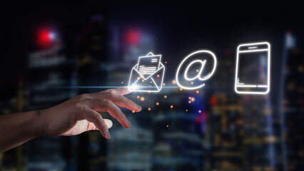 Businessman hand is touching mail envelope, email and smartphone line icon with tower background at...