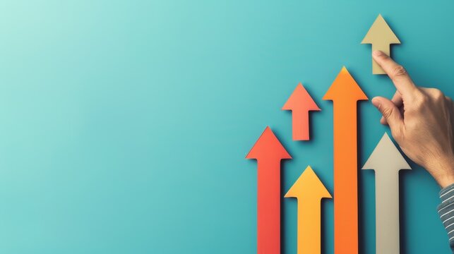 Hand pointing at multicolored arrows growing over blue background. Concept of growth, progress, success, and achievement in business and finance.