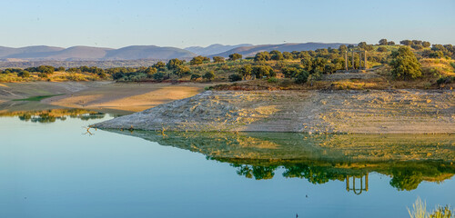 reflections in the water of the Valdecañas reservoir in Extremadura