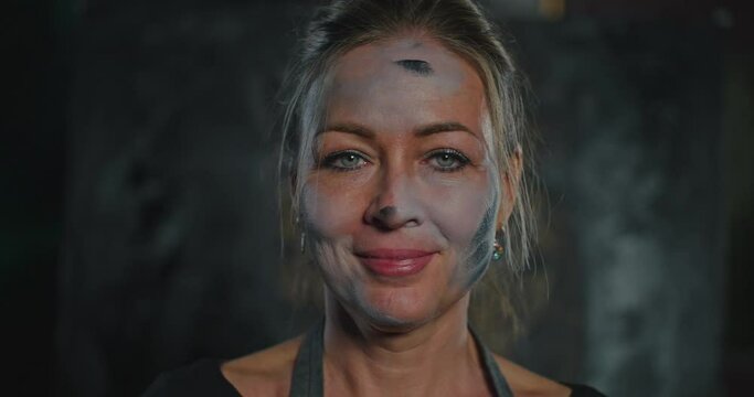 Woman in Black Apron With Paint on Face