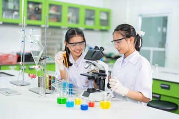 Fototapeta premium Equipped with state-of-the-art instruments like the electron microscope female scientists delve into the intricacies of molecular structures, unlocking secrets that hold the potential to improve lives