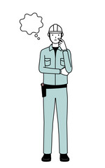 Man in helmet and workwear thinking while scratching his face.