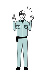 Man in helmet and workwear taking security measures for his phone.