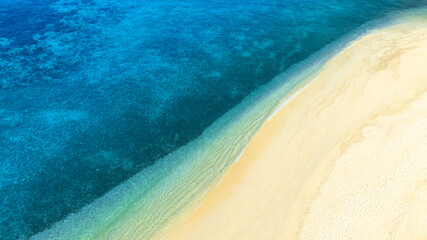 Nature of the beach and sea Summer with sunshine, sandy beaches, clear blue waters sparkling against the blue sky. On an island with good ecology and environment Background for summer vacation concept