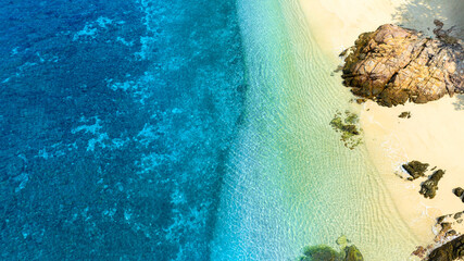 Nature of the beach and sea Summer with sunshine, sandy beaches, clear blue waters sparkling against the blue sky. On an island with good ecology and environment Background for summer vacation concept