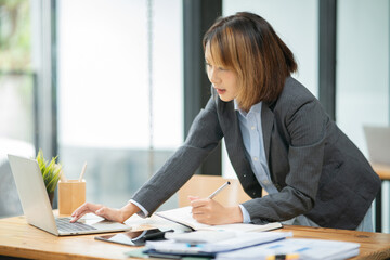 Asian business woman working with laptop at office.