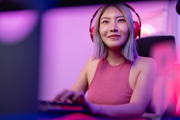 Asian beautiful esport woman gamer play online video game on computer. 