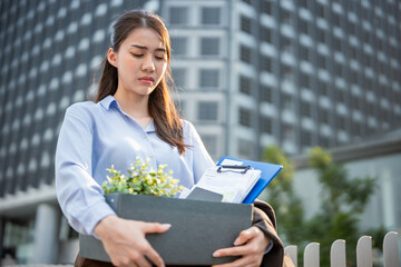 Asian businesswoman walking outdoors after unemployment from company. 