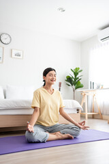 Asian young beautiful sportswoman doing yoga pilates workout at home.