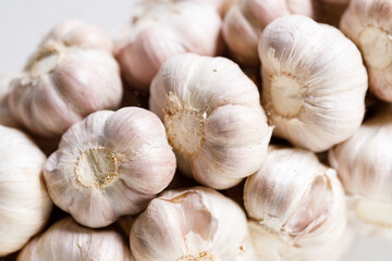Ripe organic garlic clove and bulb on white wooden background.  Close-up. Selective focus.