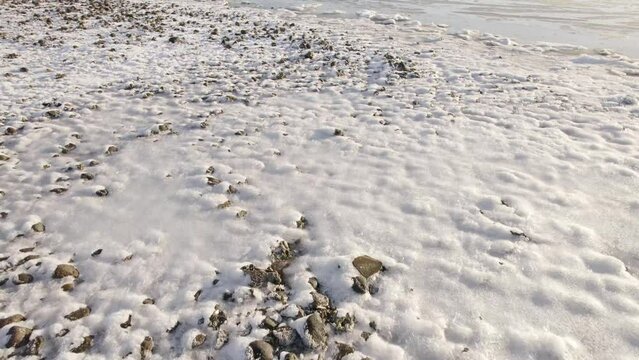 Aerial Drone Tilt Up Reveal Frozen Laguna at Winter Time