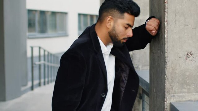 Unhappy sad Indian business man frustrated stress pensive feeling bad after company lost job unemployment problem financial crisis. Arabian Hindu freelancer guy stay at office business center building