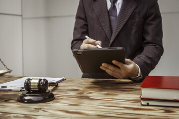 A businessman in a formal suit signs a contract, hands close up, suggesting possible bribery, at a...