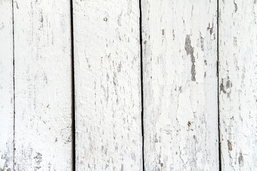 The texture of old boards painted with white paint. Vintage peeling paint texture.