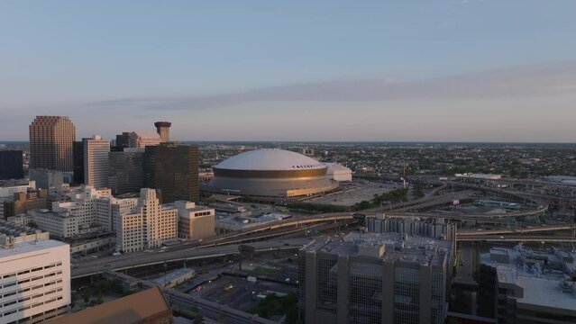 Enchanting cityscape of downtown new orleans at twilight, featuring iconic architecture, Caesars Superdome and the vibrant city life at dusk