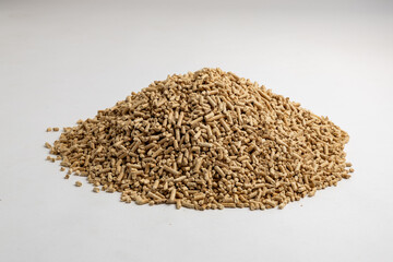pile of wood pellets for heating with human hand white background