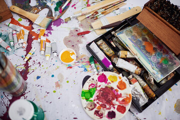 Equipment, art and above with tools in studio, creative and mess for artwork and product placement. Color, texture and durability of painting brush, small business and supplies for palette and home