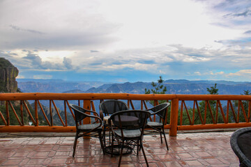 Beautiful cafe in the middle of the impressive Copper Canyon. Mountains and clouds background