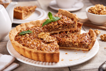Tart with walnuts and caramel cream filling. Sweet homemade dessert.