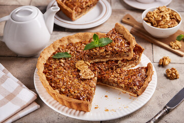 Tart with walnuts and caramel cream filling. Sweet homemade dessert.