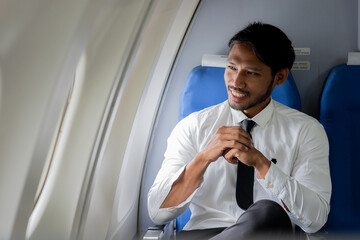 Happy young male traveler on airplane, young male passenger collecting travel concept flight travel