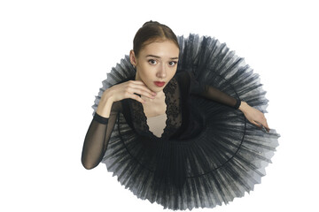 portrait of a young ballerina in a black tutu dancing with her hands moving top view, immersion in...