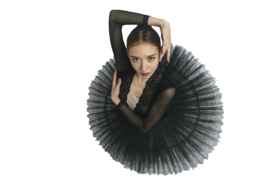 portrait of a young ballerina in a black tutu dancing with her hands moving top view, immersion in dance, isolated on transparent background, png