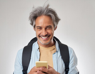 Portrait of handsome grey hair man with mobile phone on white background smiling happiness