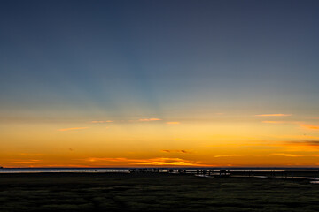 Sea shore scenic tourist pathway bridge under sunset glow with rosy clouds. Gaomei Wetlands, Taichung City, Taiwan