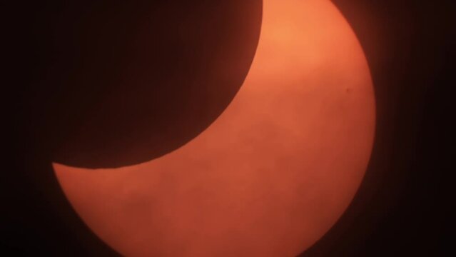 Movement of Clouds in Front of Sun During a Solar Eclipse. Moon Cast Shadows Covering During Partial Solar Eclipse With Clouds Moving. Partial Solar Eclipse When Sun Rise in Europe October 25, 2022. 
