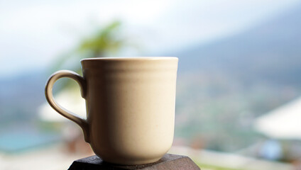 A cup of coffee on mountain. Empty cup of tea or coffee. Inspirational motivational backgrounds.