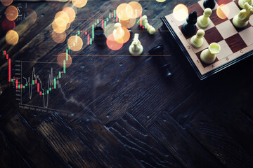 Chess game with black and white wooden chips on wooden board. At sunset. Realistic.