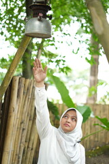 Asian female model in white hijab is in the park