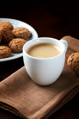 Cup of coffee on wooden background. Close up.