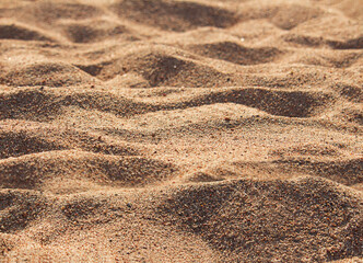 Orange waves of beach and desert sand with blur with sunset or morning light. Nature background