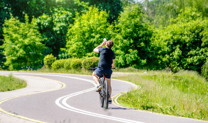 Fototapeta premium Cyclist ride on the bike path in the city Park 